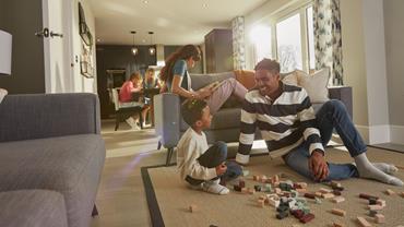 Redrow Buying with Redrow Armed forces deposit contribution Family relaxing in open plan kitchen