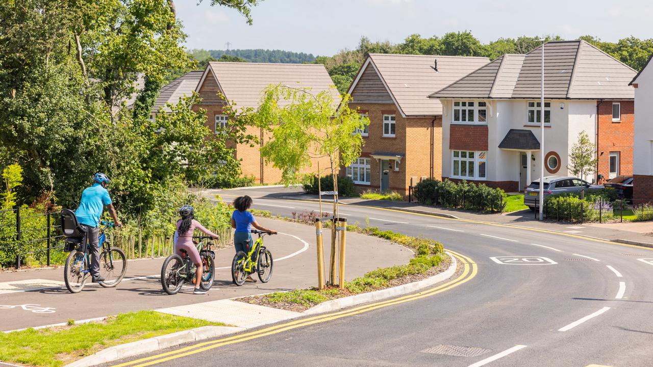 Redrow - Inspiration - Family cycling on redrow development