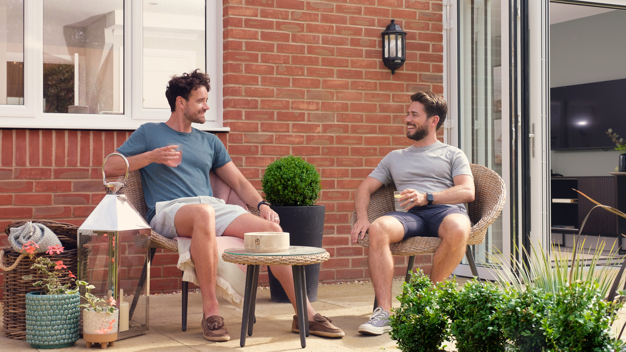 Redrow - Inspiration - Couple sit in heritage house garden
