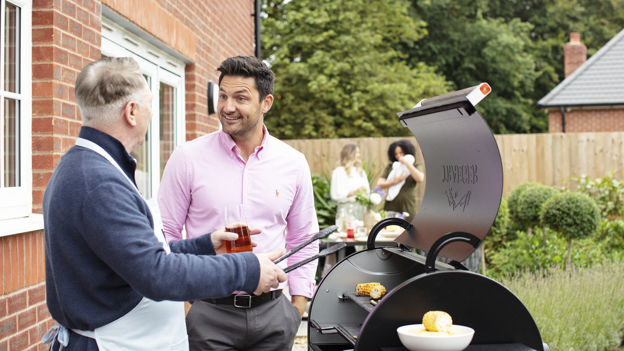 Redrow | Inspiration | Two men talking at barbeque in garden