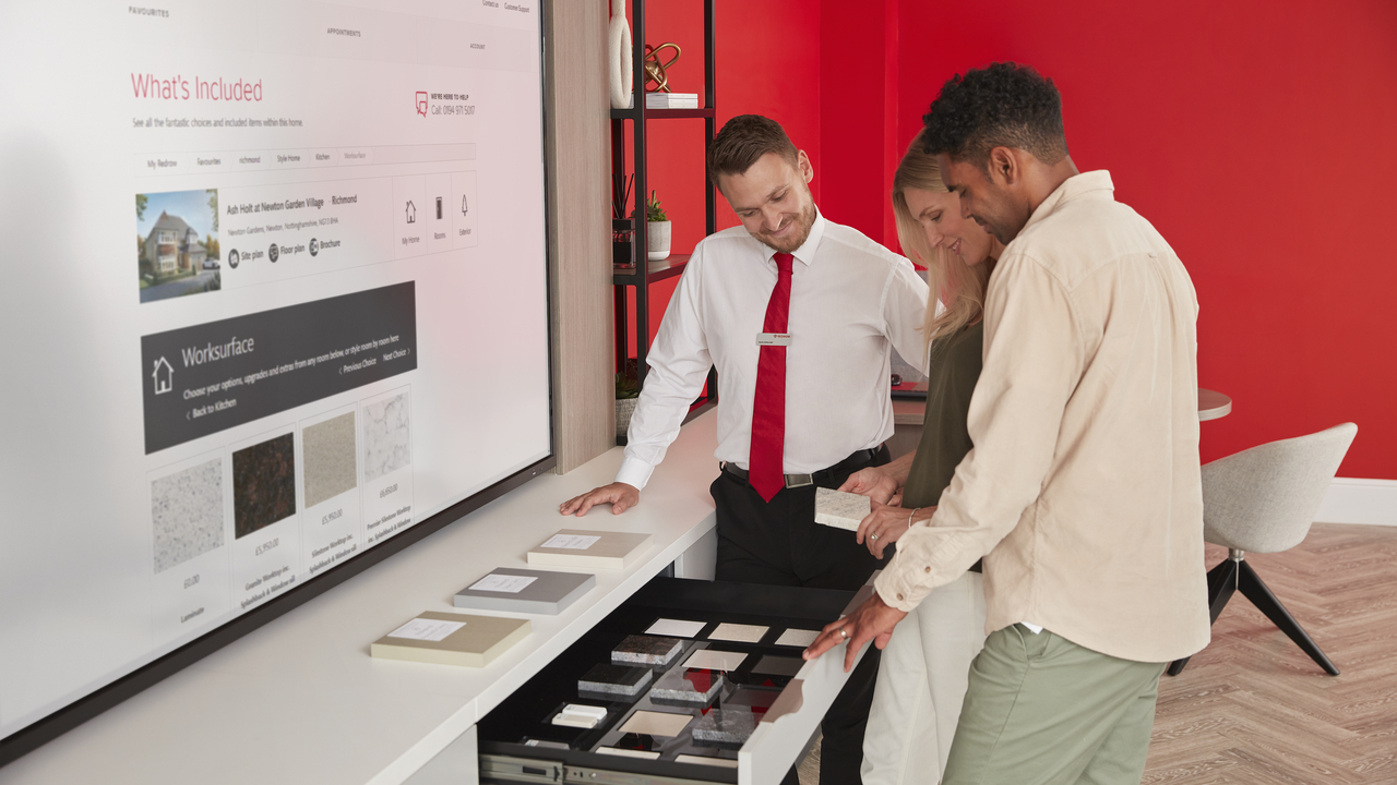 Redrow - Inspiration - Couple looking at My Redrow Extras at a development