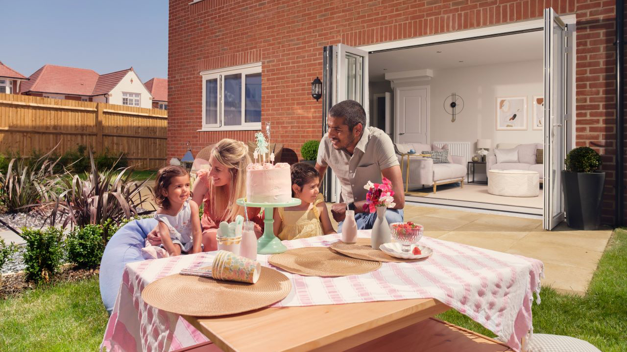 Redrow - Inspiration - Family eating cake in Redrow garden