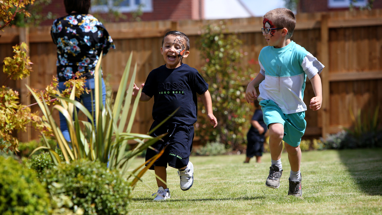 Redrow - Inspiration - 2 boys racing in the garden