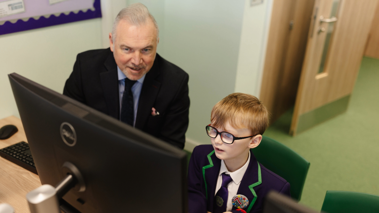 Redrow - News - Teacher and student looking at a computer