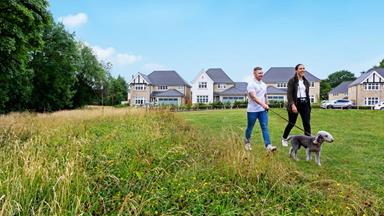 Redrow - News - Couple walking a dog